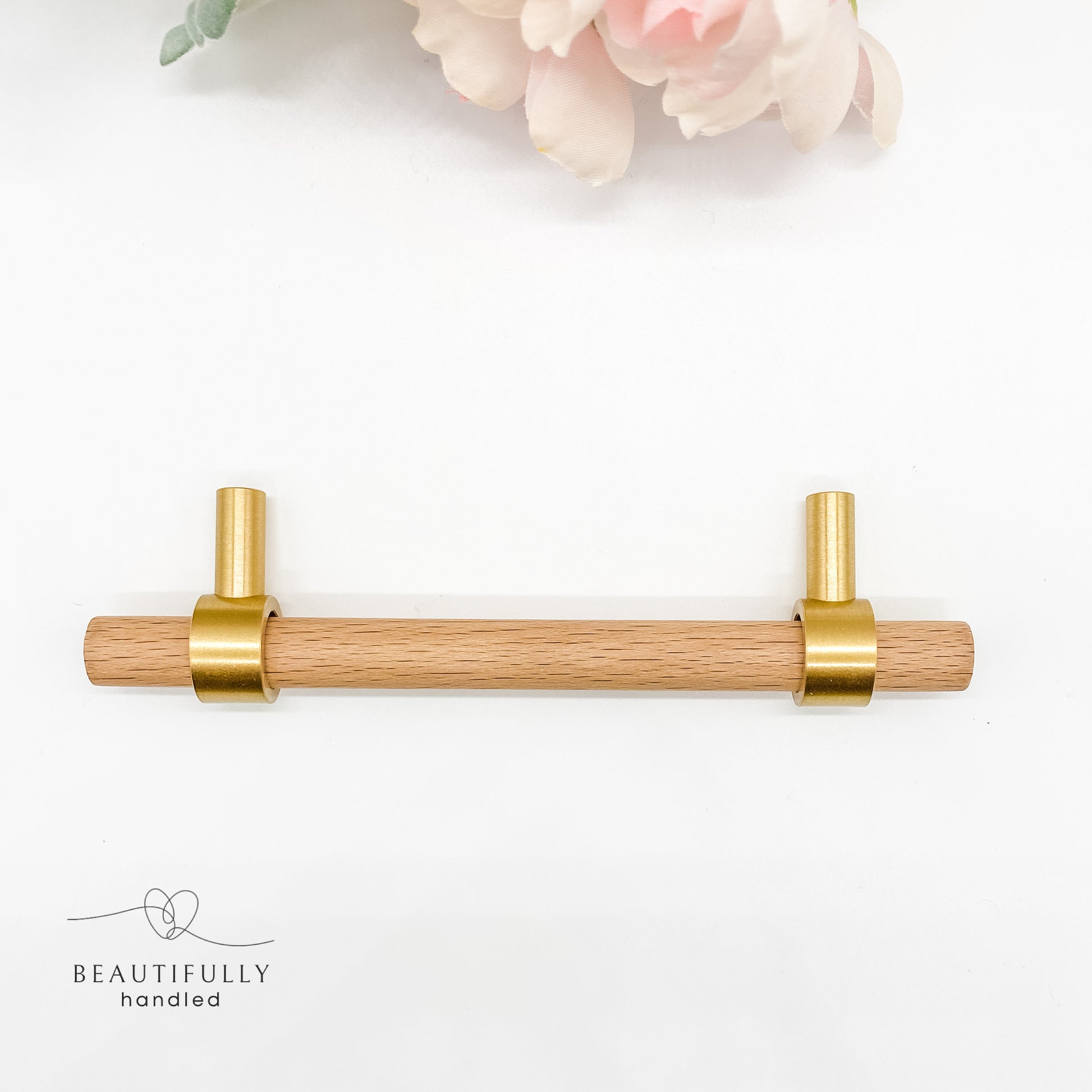 overhead view of 128mm timber kitchen handle with brass feet