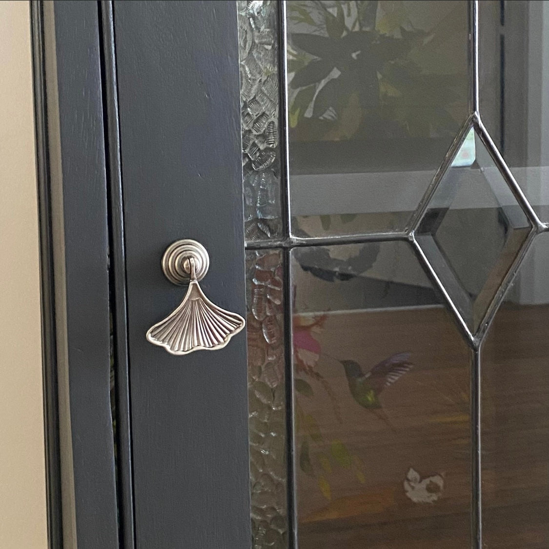 black painted glass cabinet with walnut stained top and dark silver gingko leaf drawer handle 