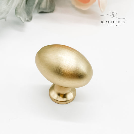 Brushed gold oval-shaped solid knob