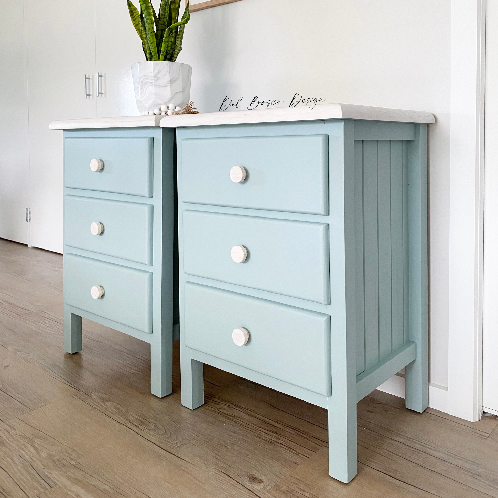 soft blue coastal bedside tables with whitewashed tops using raw wooden drawer knobs 