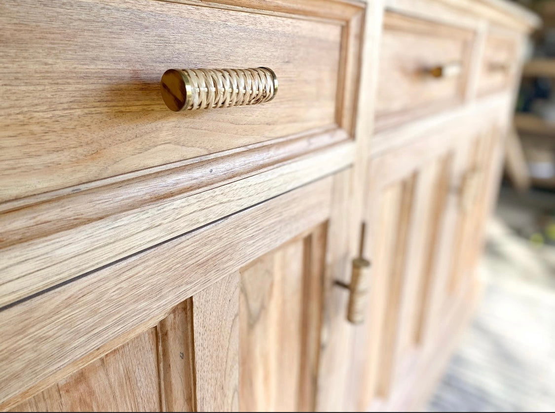 rattan handle with brass edges on coastal buffet sideboard