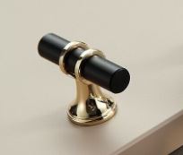 black drawer handle with gold trim on timber kitchen door