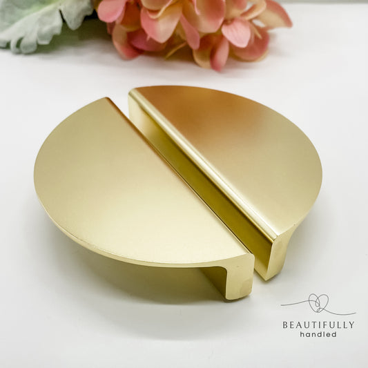 gold half moon drawer handle 10cm on plain white background