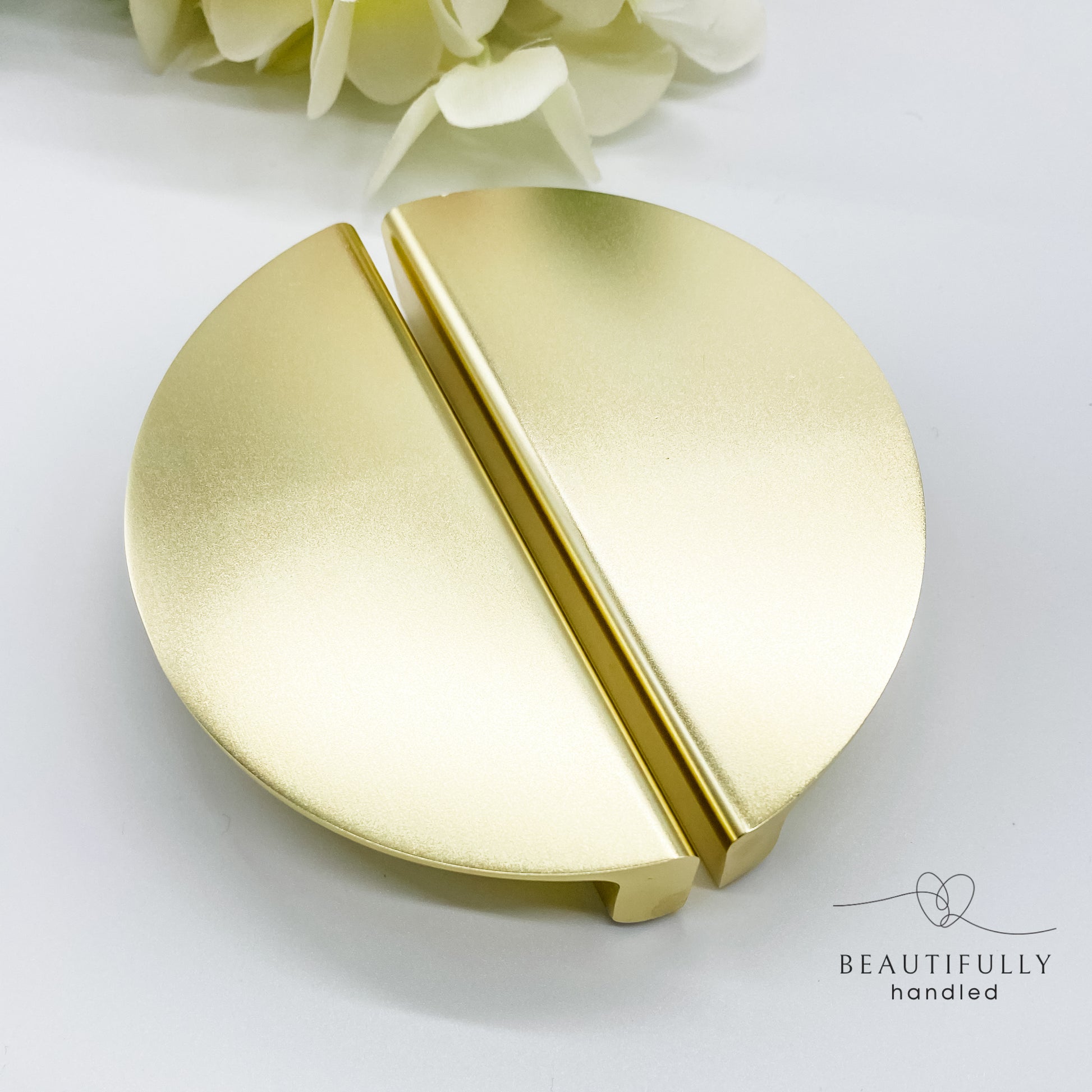 gold half moon drawer handle on plain white background