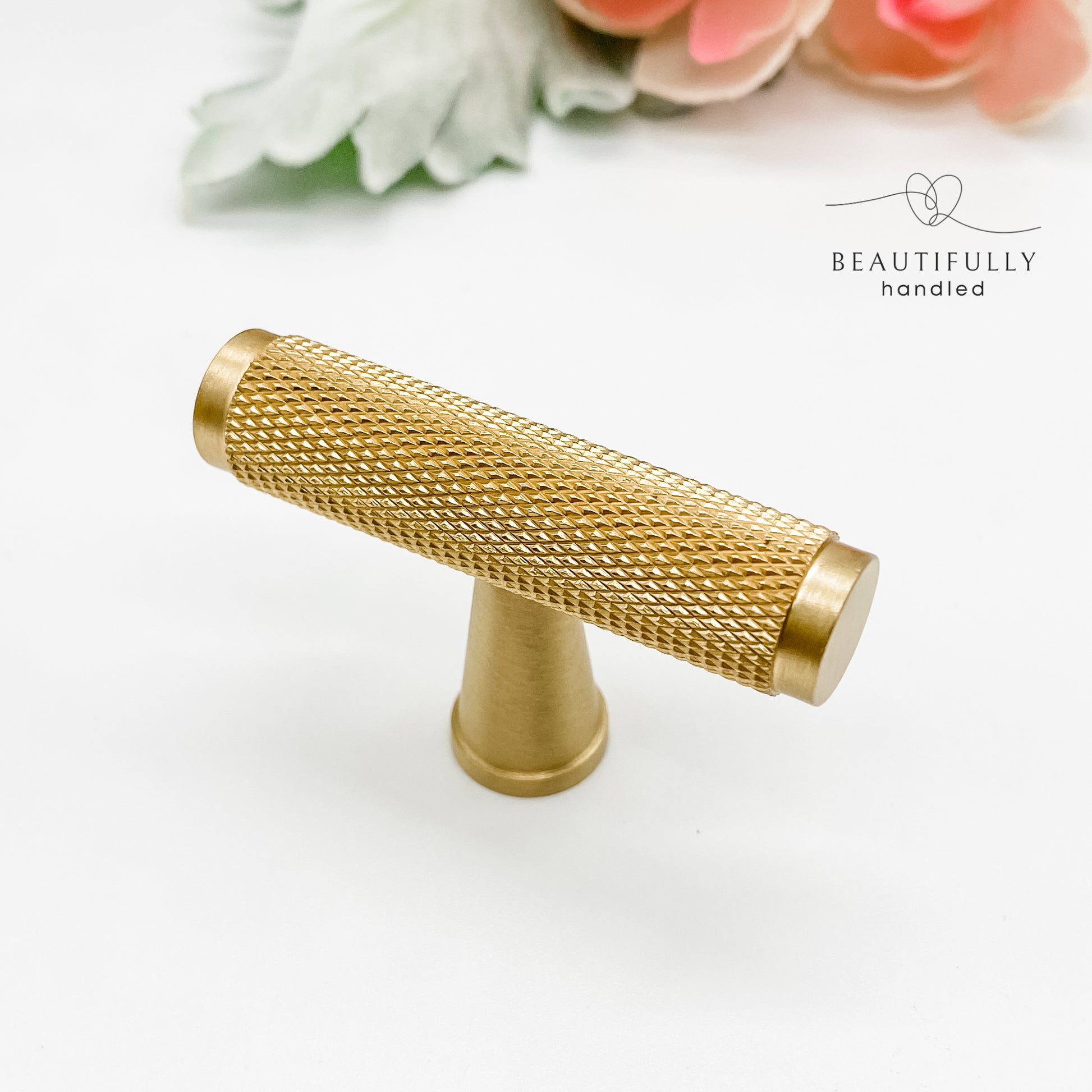 solid knurled brass t bar drawer handle on plain white background
