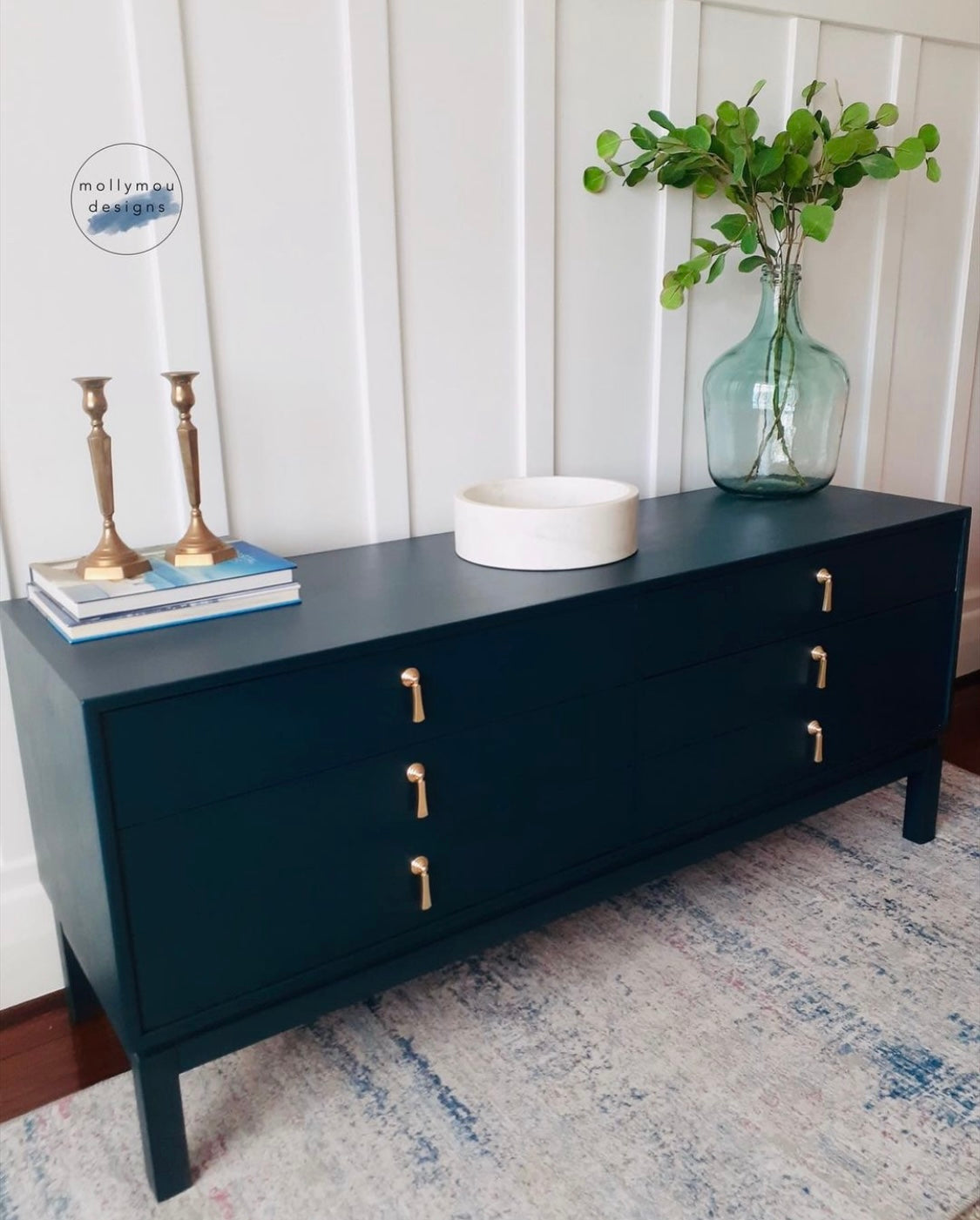 deep blue painted chest of drawers with gold drop drawer handles